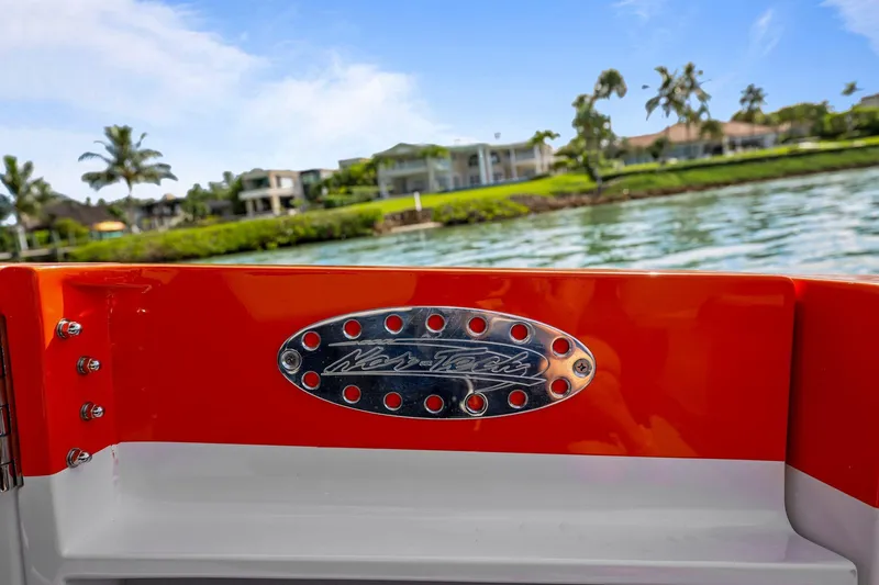 Slide: The Image of 2026 Nor-Tech 390 Sport Center Console boat with logo, scenic waterfront view. - 77