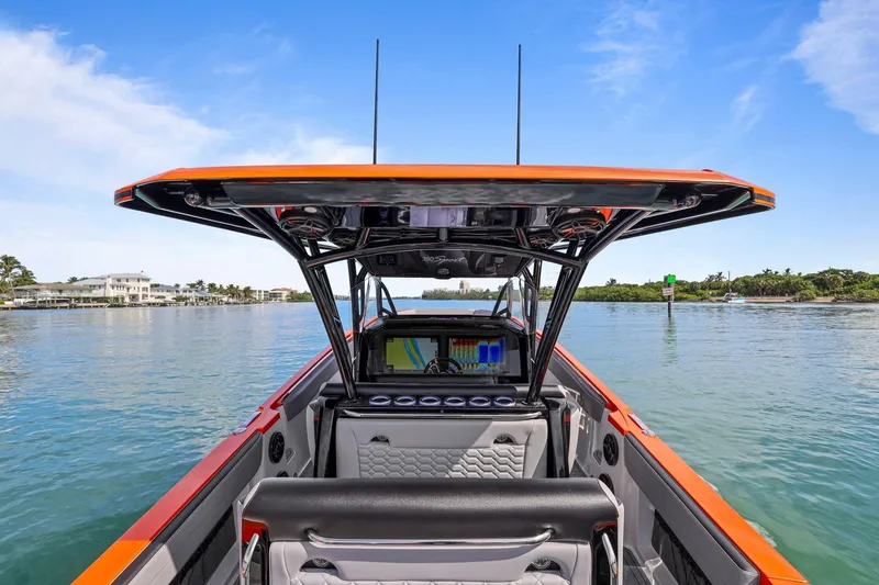 Slide: The Image of 2026 Nor-Tech 390 Sport Center Console boat on calm water, featuring modern design and technology. - 79