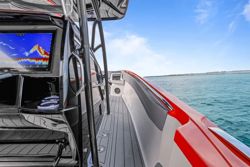 Slide: The Image of 2026 Nor-Tech 390 Sport Center Console boat with advanced navigation system on open water. - 80