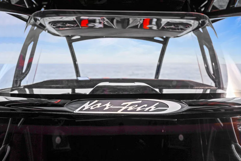 Slide: The Image of 2026 Nor-Tech 390 Sport Center Console boat with sleek design and ocean backdrop. - 81