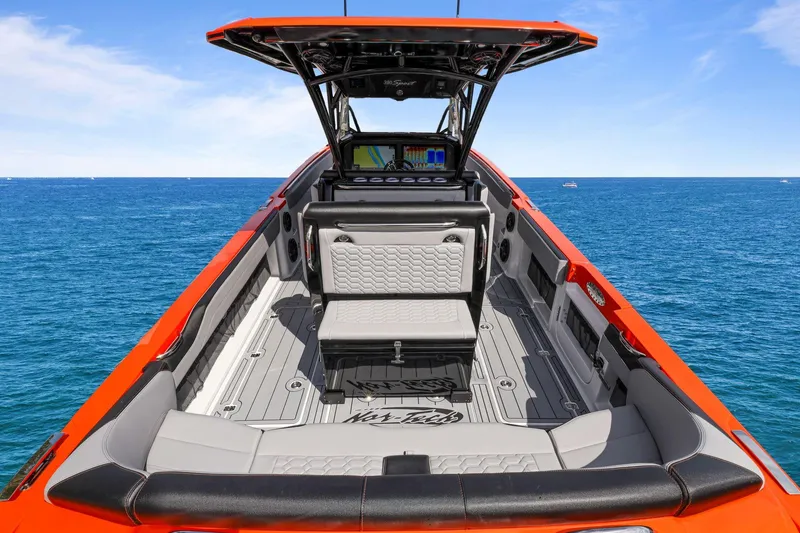 Slide: The Image of 2026 Nor-Tech 390 Sport Center Console boat on open sea, featuring sleek design and advanced navigation. - 82