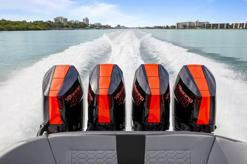 Slide: The Image of 2026 Nor-Tech 390 Sport Center Console with four powerful outboard engines on open water. - 83