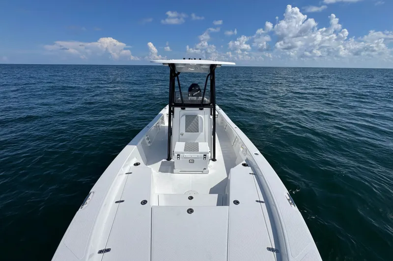 Slide: The Image of 2026 BlackJack 256 Bay boat interior with cushioned seating and outboard motor. - 10