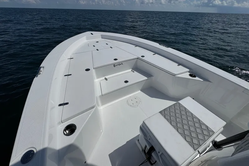 Slide: The Image of 2026 BlackJack 256 Bay boat dashboard with steering wheel and electronic controls. - 14