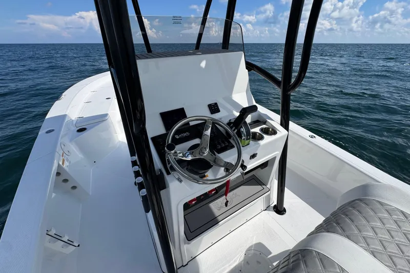 Slide: The Image of 2026 BlackJack 256 Bay boat with trolling motor on deck in a sunny marina. - 18