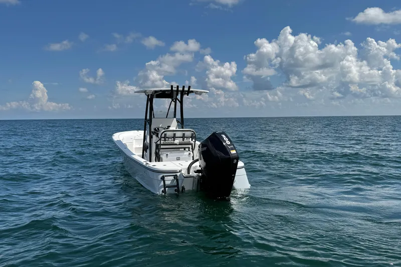 Slide: The Image of 2026 BlackJack 256 Bay boat on trailer, parked outdoors under clear blue sky. - 3