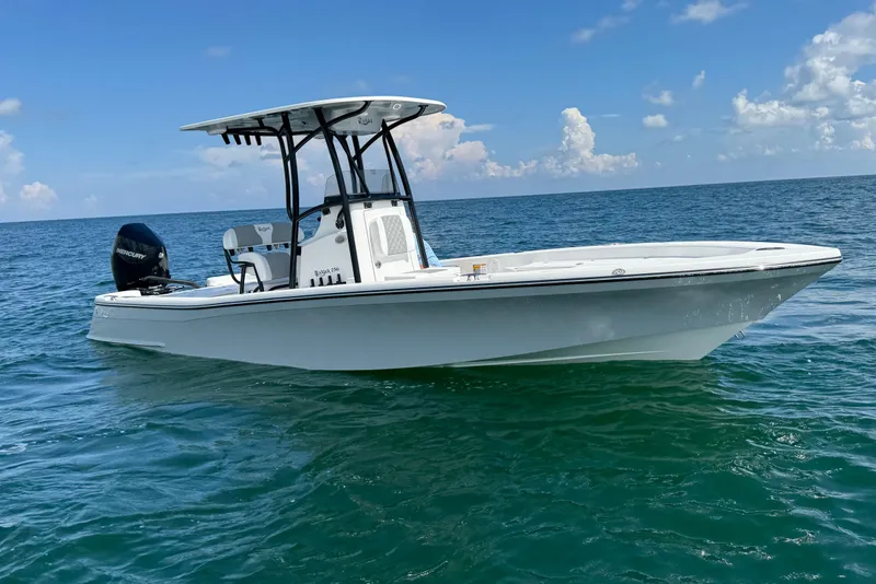 Slide: The Image of 2026 BlackJack 256 Bay boat on trailer, parked outdoors under clear blue sky. - 6