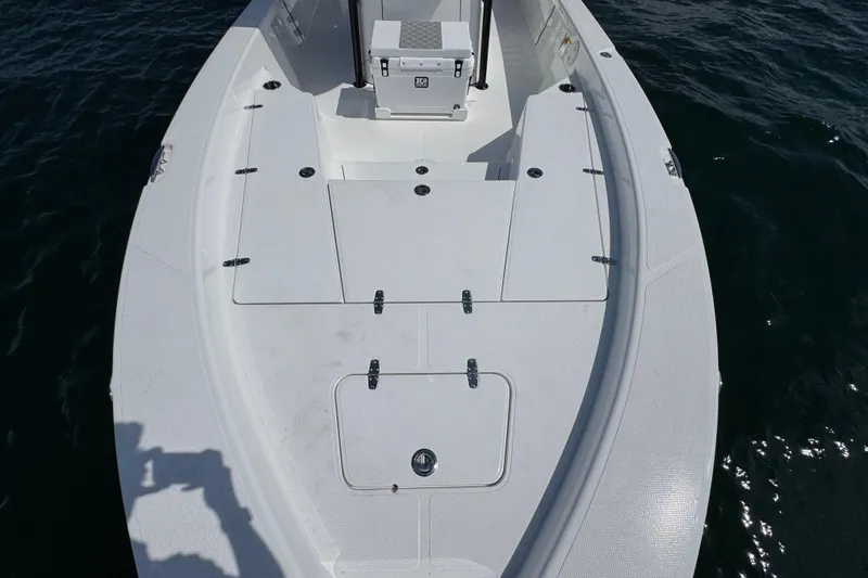 Slide: The Image of 2026 BlackJack 256 Bay boat with Mercury engine, parked outdoors. - 9