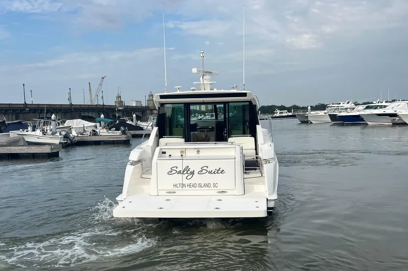 Slide: The Image of 2023 Tiara Yachts C44 Coupe in marina, rear view, Hilton Head Island. - 17