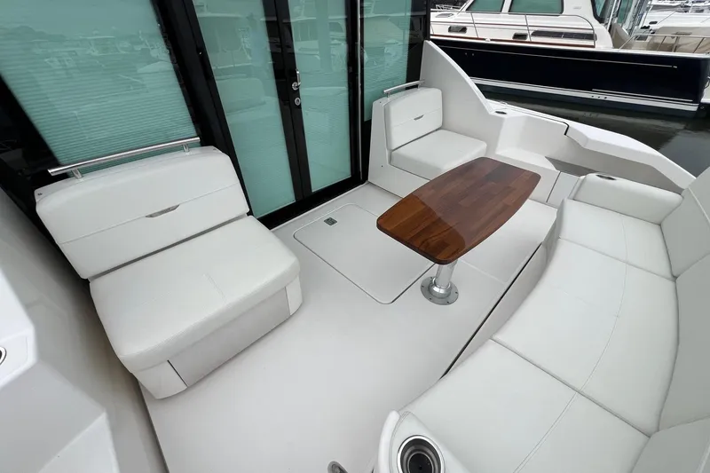 Slide: The Image of Luxurious 2023 Tiara Yachts C44 Coupe interior with elegant seating and wooden table. - 23