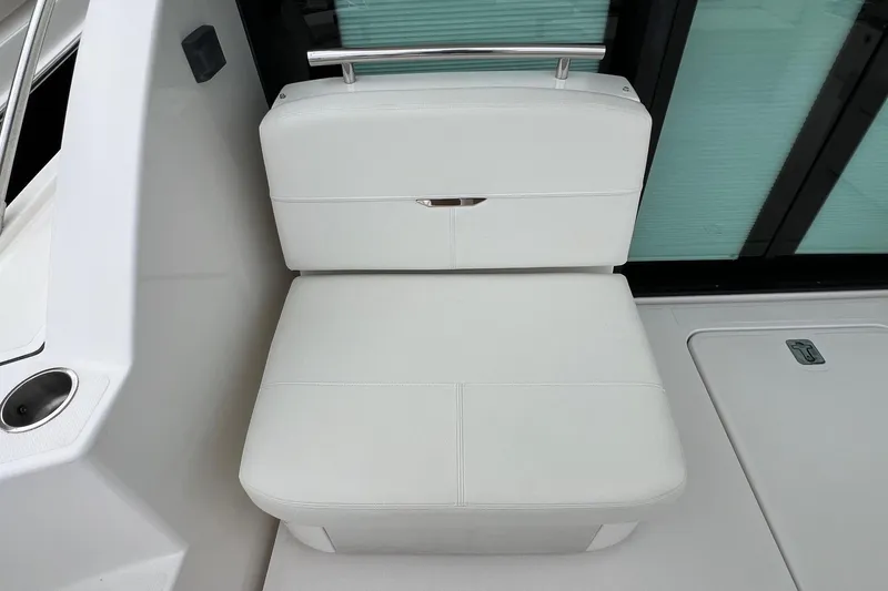 Slide: The Image of White seating area on 2023 Tiara Yachts C44 Coupe, featuring sleek design and modern finishes. - 24