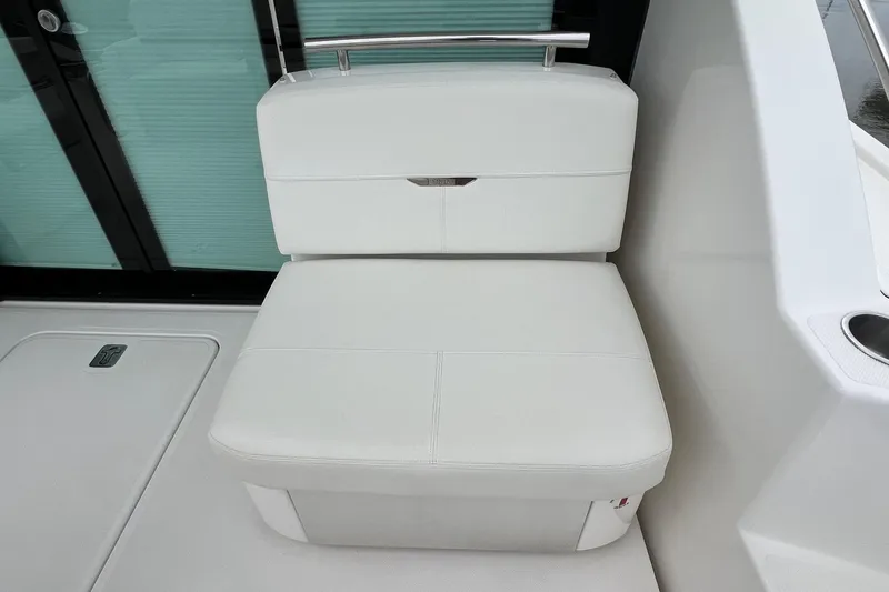 Slide: The Image of 2023 Tiara Yachts C44 Coupe white seating area with sleek design and modern finish. - 25