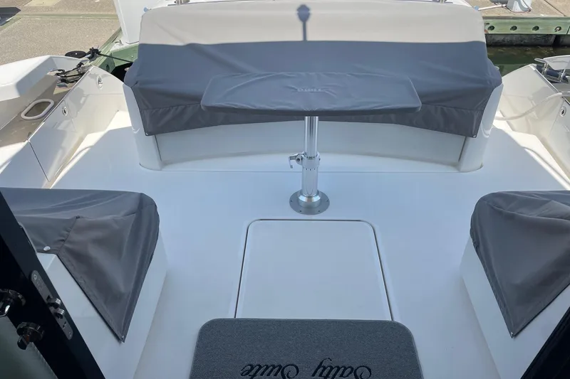 Slide: The Image of 2023 Tiara Yachts C44 Coupe cockpit with covered seating and table. - 29