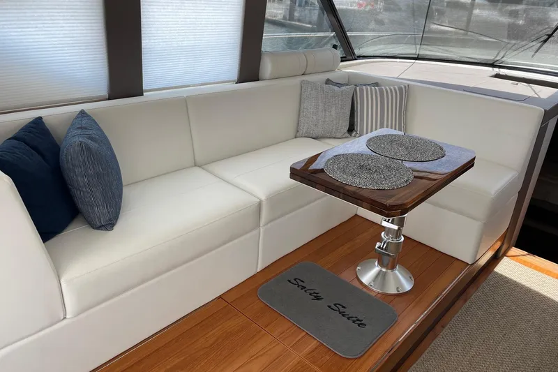 Slide: The Image of Luxurious interior of 2023 Tiara Yachts C44 Coupe with elegant seating and table. - 30