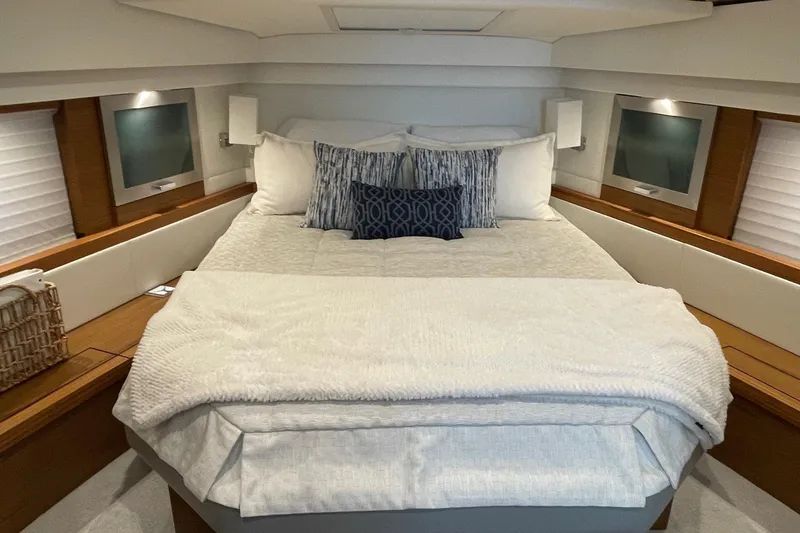 Slide: The Image of Luxurious bedroom interior of 2023 Tiara Yachts C44 Coupe with cozy bedding and ambient lighting. - 34