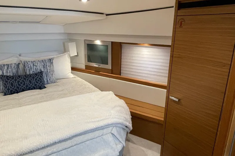 Slide: The Image of Luxurious bedroom interior of 2023 Tiara Yachts C44 Coupe with modern design and cozy bedding. - 35