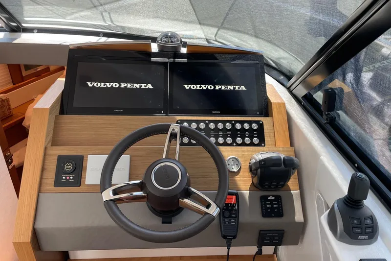 Slide: The Image of 2023 Tiara Yachts C44 Coupe helm with Volvo Penta displays and controls. - 40