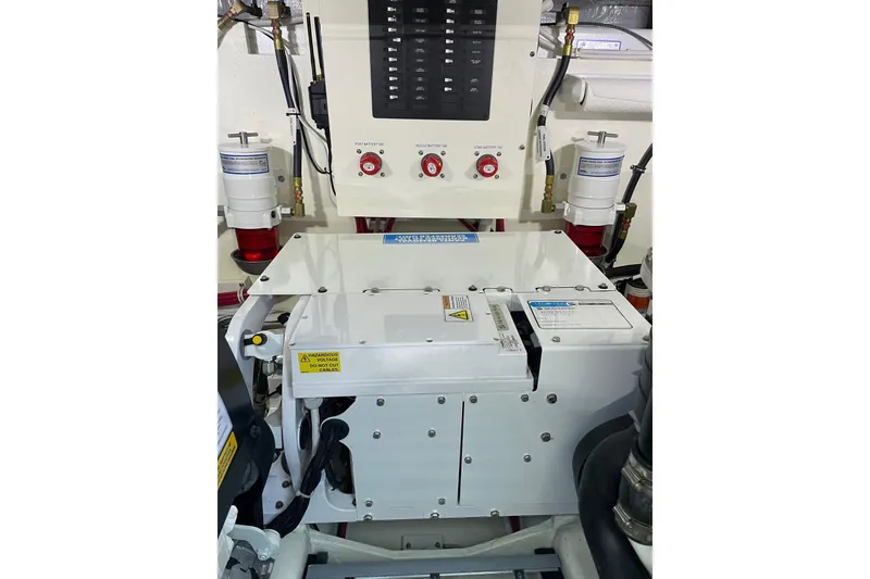 Slide: The Image of Engine room of 2023 Tiara Yachts C44 Coupe, featuring control panel and components. - 50