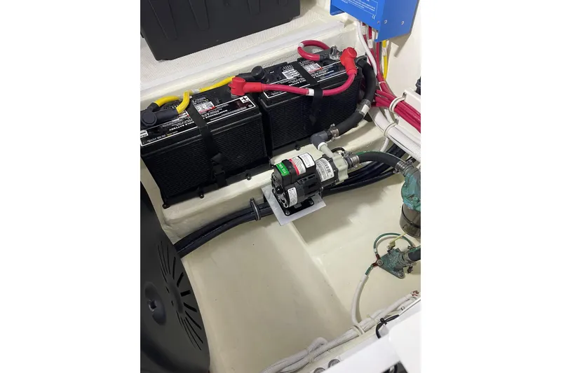 Slide: The Image of Engine compartment of 2023 Tiara Yachts C44 Coupe, featuring batteries and wiring. - 51