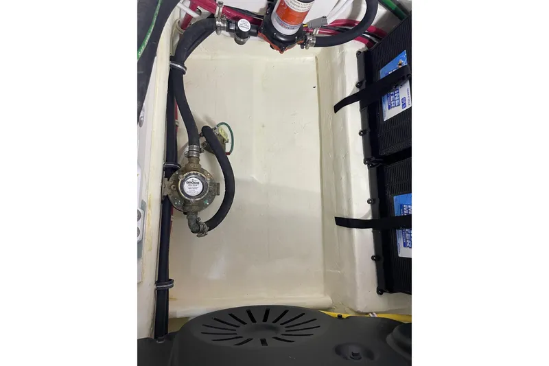Slide: The Image of Engine compartment of 2023 Tiara Yachts C44 Coupe, showcasing mechanical components and wiring. - 55