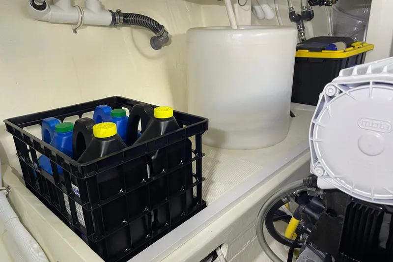 Slide: The Image of Engine room of 2023 Tiara Yachts C44 Coupe with storage containers and equipment. - 59