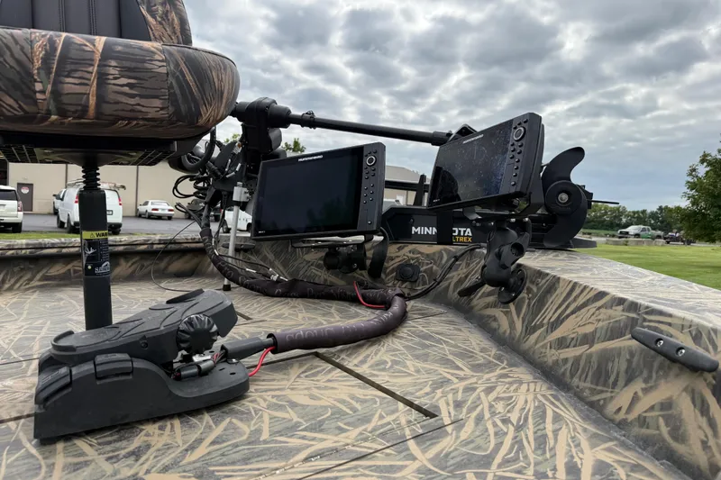 Slide: The Image of 2023 Lowe Roughneck 2070SC boat with Minn Kota Ultrex trolling motor and camo seating. - 11