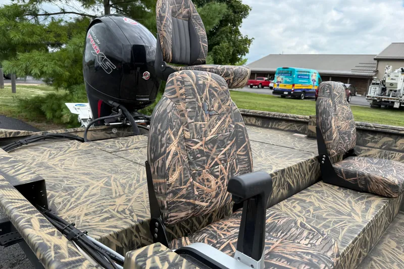 Slide: The Image of 2023 Lowe Roughneck 2070SC boat with camo seats and powerful outboard motor. - 15