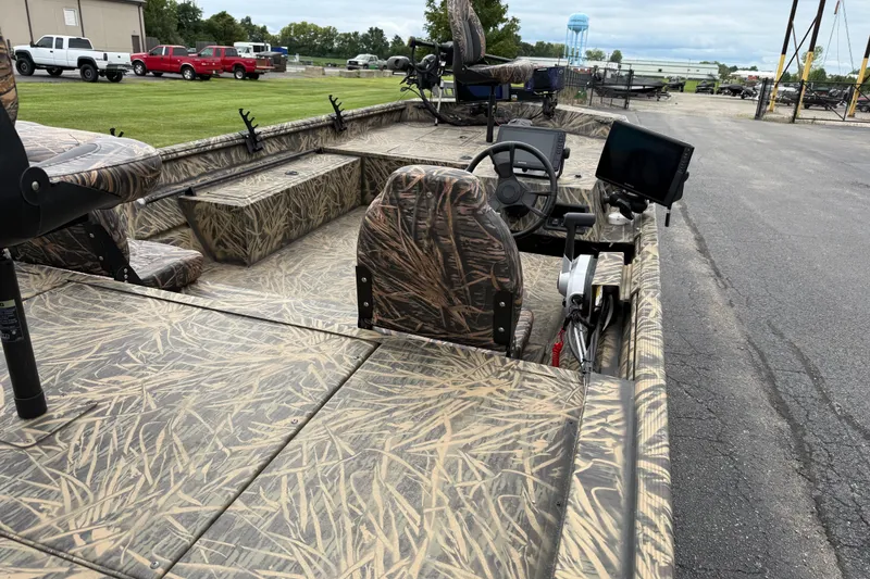 Slide: The Image of 2023 Lowe Roughneck 2070SC boat with camouflage design, featuring steering console and seating. - 17
