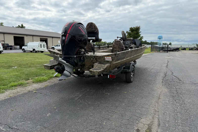 Slide: The Image of 2023 Lowe Roughneck 2070SC boat with camo design and powerful outboard motor. - 3