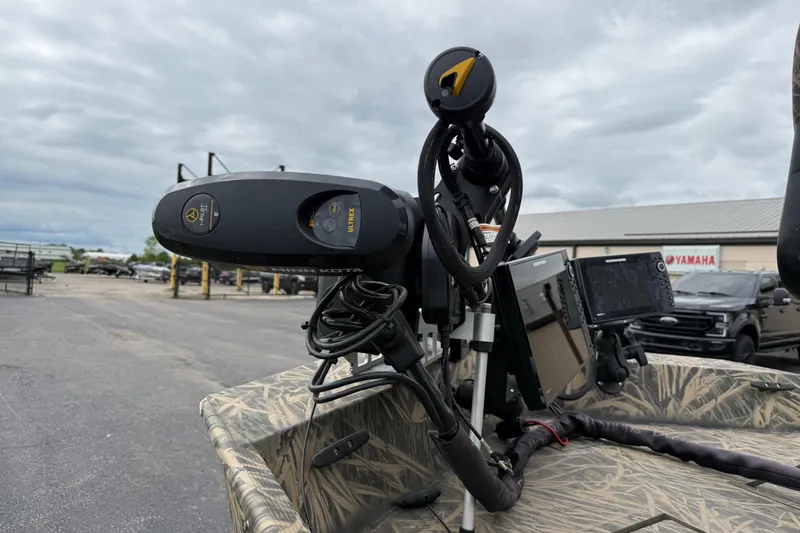 Slide: The Image of 2023 Lowe Roughneck 2070SC boat with advanced navigation equipment and camo design. - 9