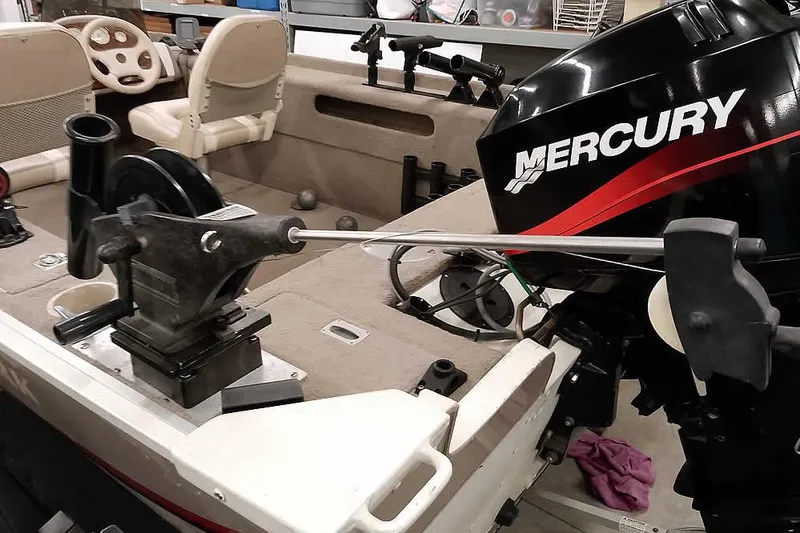 Slide: The Image of 2005 Monark Signature 1601 boat interior with Mercury engine and fishing equipment. - 10