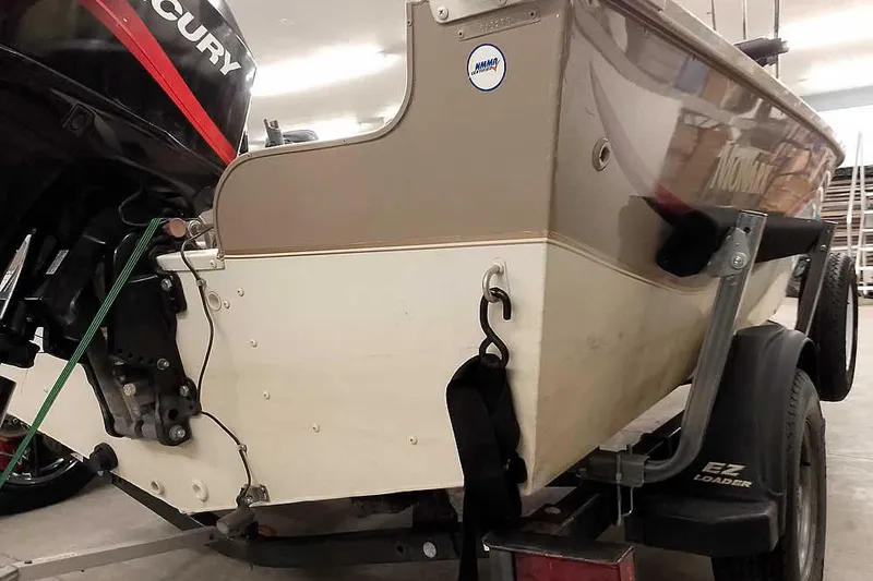 Slide: The Image of 2005 Monark Signature 1601 boat on trailer with Mercury outboard motor in garage. - 12