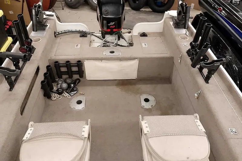Slide: The Image of Interior of a 2005 Monark Signature 1601 fishing boat with rod holders and seating. - 17