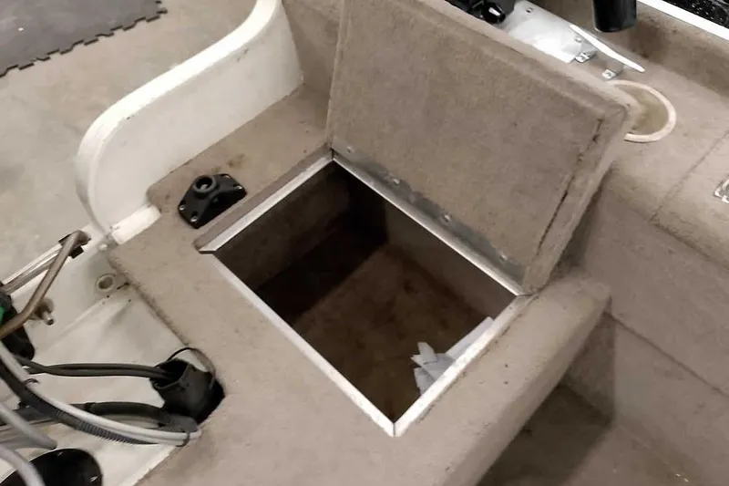 Slide: The Image of Open storage compartment on a 2005 Monark Signature 1601 boat interior. - 19
