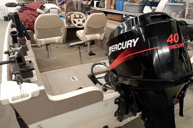 Slide: The Image of 2005 Monark Signature 1601 boat with Mercury 40 outboard motor in a garage setting. - 2