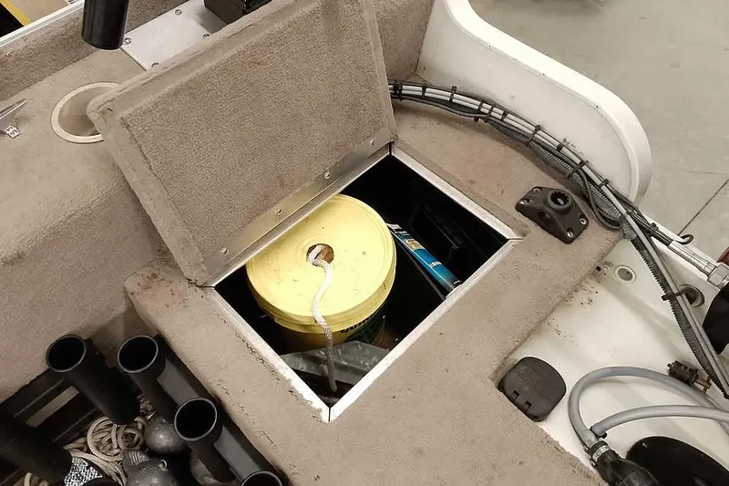 Slide: The Image of Open storage compartment on 2005 Monark Signature 1601 boat with yellow bucket inside. - 20