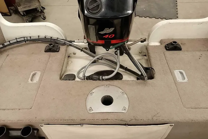 Slide: The Image of 2005 Monark Signature 1601 boat interior with motor and deck details. - 21