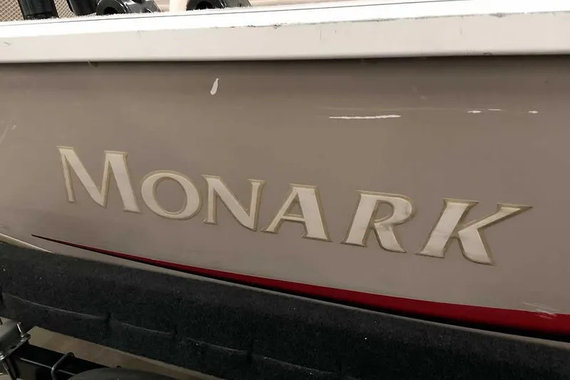Slide: The Image of Monark Signature 1601 boat, 2005 model, featuring bold lettering on the hull. - 23