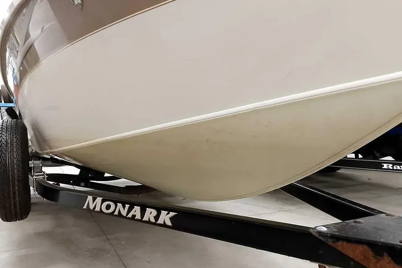 Slide: The Image of 2005 Monark Signature 1601 boat on trailer, close-up view of hull and wheel. - 5