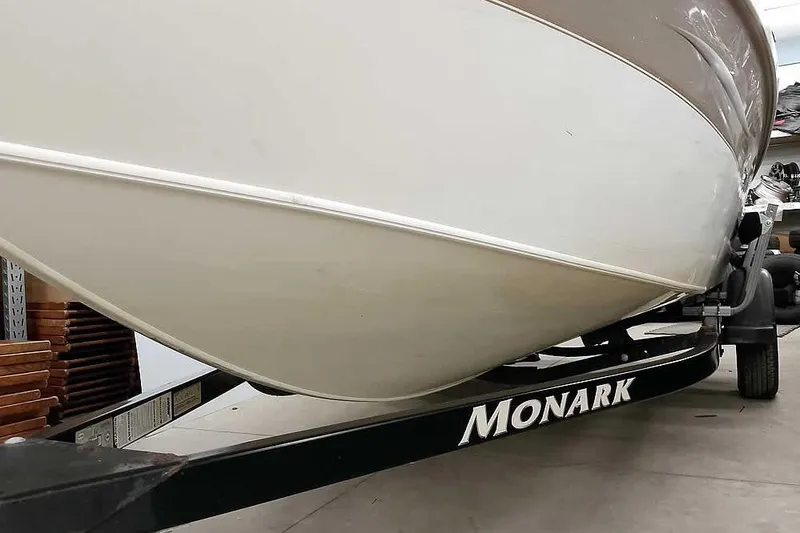 Slide: The Image of 2005 Monark Signature 1601 boat on trailer, close-up view of hull and branding. - 6