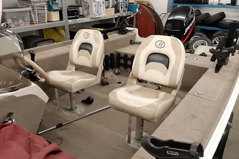 Slide: The Image of 2005 Monark Signature 1601 boat interior with beige seats and steering wheel. - 8