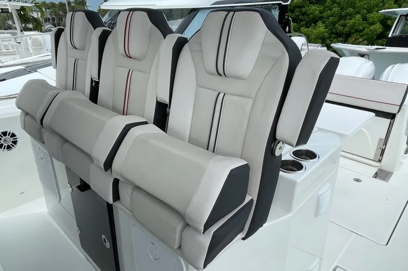 Slide: The Image of 2024 Jeanneau Leader 10.5 CC boat interior with seating, docked at marina. - 15