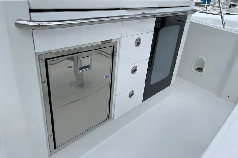 Slide: The Image of 2024 Jeanneau Leader 10.5 CC boat interior with modern seating and control area. - 8