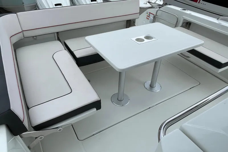 Slide: The Image of 2024 Jeanneau Leader 10.5 CC boat interior with open cabin door at a marina. - 9