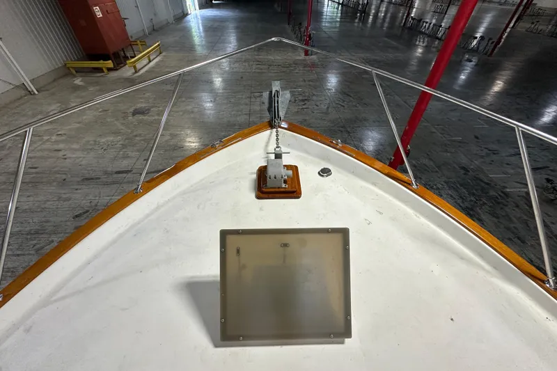 Slide: The Image of Bow view of 1982 Egg Harbor 42 Flybridge Motoryacht in a warehouse setting. - 10