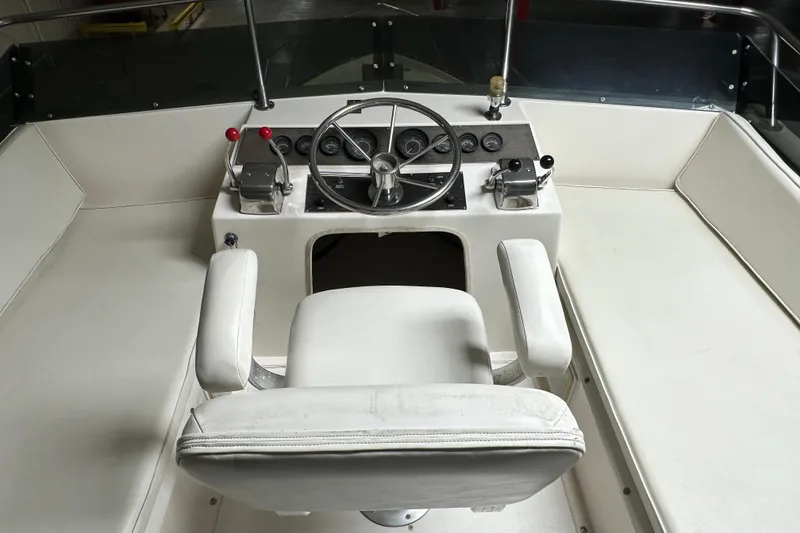 Slide: The Image of 1982 Egg Harbor 42 Flybridge Motoryacht helm with steering wheel and controls. - 24