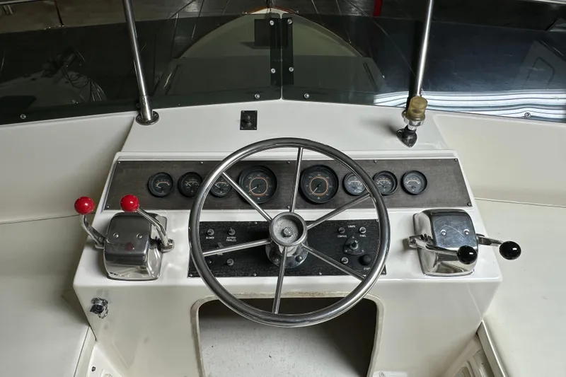 Slide: The Image of 1982 Egg Harbor 42 Flybridge Motoryacht helm with steering wheel and control panel. - 25