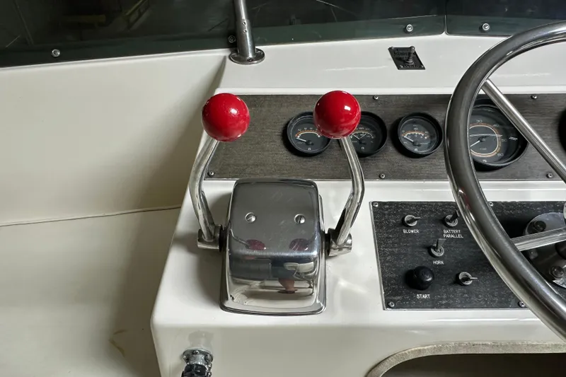 Slide: The Image of Control panel of a 1982 Egg Harbor 42 Flybridge Motoryacht with throttle levers and gauges. - 26