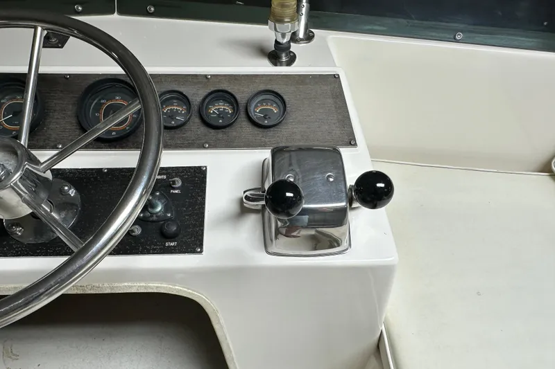 Slide: The Image of 1982 Egg Harbor 42 Flybridge Motoryacht helm with steering wheel and control panel. - 27