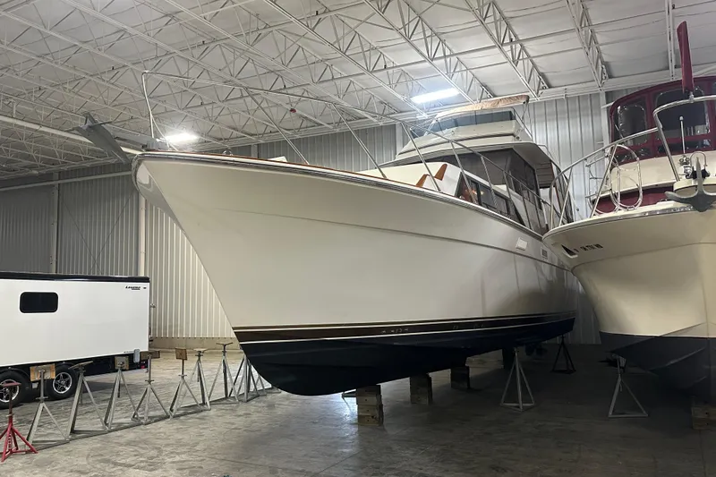 Slide: The Image of 1982 Egg Harbor 42 Flybridge Motoryacht in indoor storage, showcasing sleek design and craftsmanship. - 3
